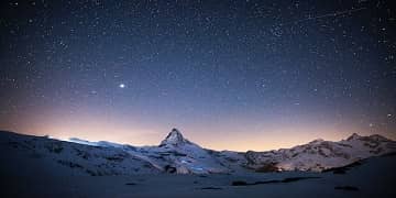 City at night with a bridge and water